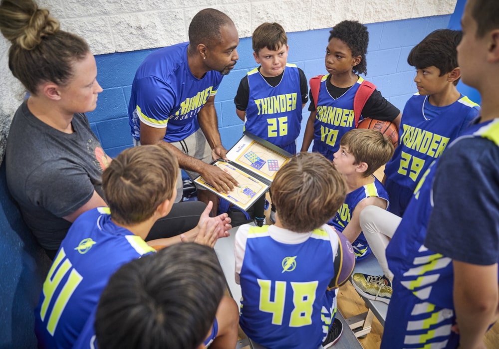 Coach with youth basketball team.